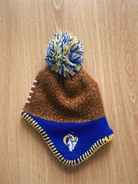 NFL Rams Infant Pom Pom Beanie Hat in Brown, Royal Blue, Yellow